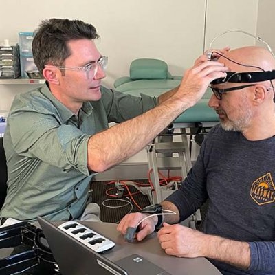 Dr David Klyne fits Wolbert van den Hoorn with a sleep monitoring device on his head